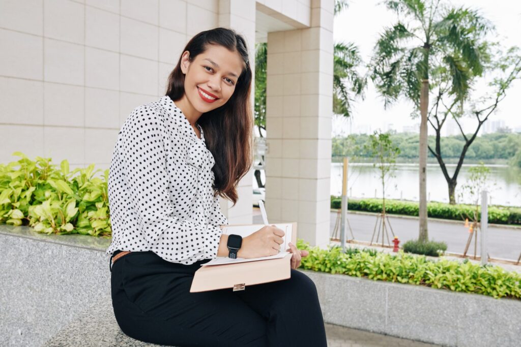 smiling woman writing in planner 2021 08 28 14 52 07 utc 1